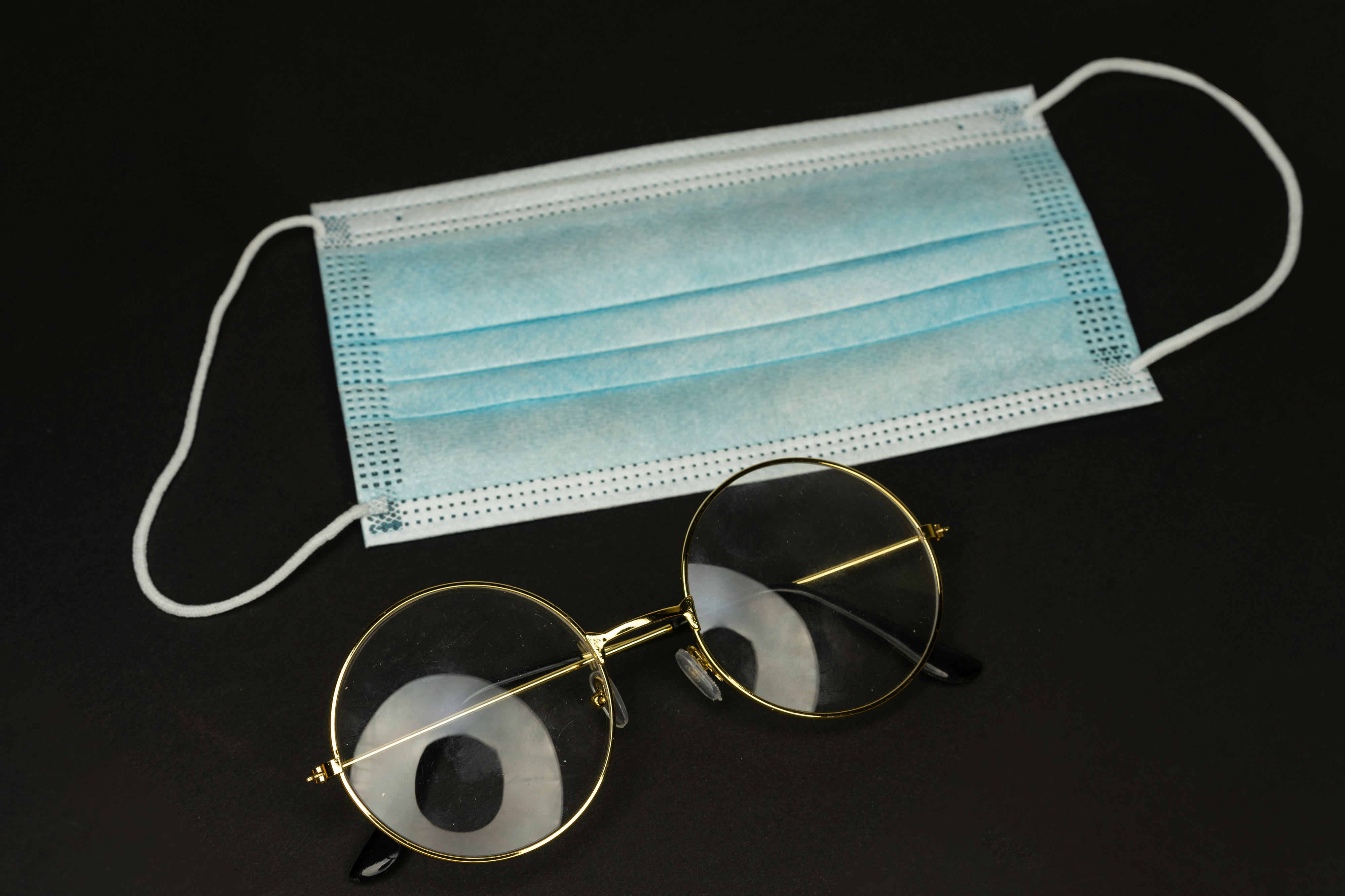 silver framed eyeglasses on black table